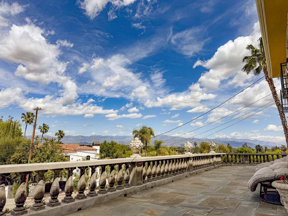 Front terrace with a stone balustrade looking across the Valley to the mountains